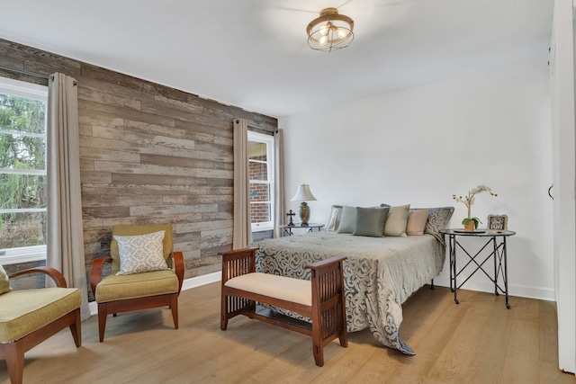 bedroom featuring wooden walls and light wood-type flooring