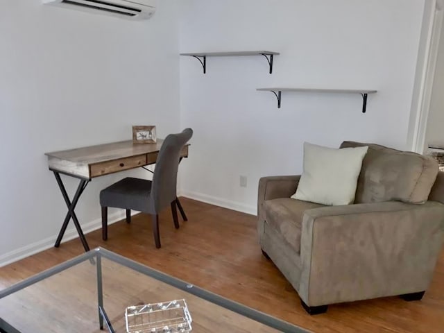 office area with hardwood / wood-style flooring and a wall unit AC