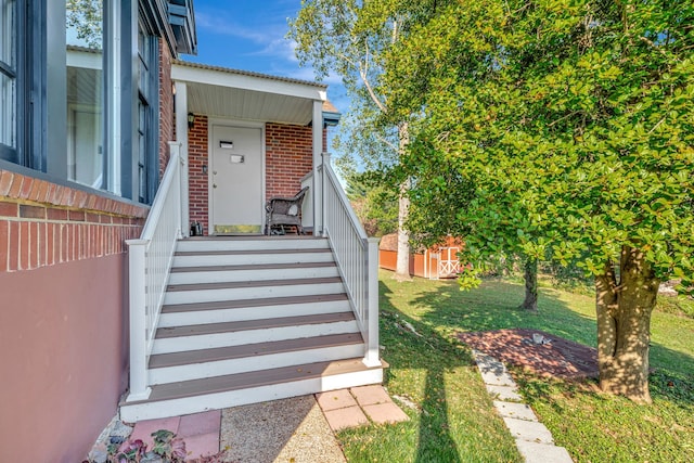 property entrance with a yard