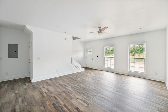 320 Moffat St Unit 101, Monteagle, TN 37356 - unfurnished living room with electric panel, wood finished floors, ceiling fan, stairway, and baseboards