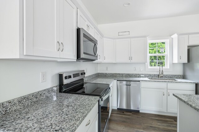 320 Moffat St Unit 101, Monteagle, TN 37356 - kitchen featuring appliances with stainless steel finishes, a sink, white cabinets, light stone counters, and dark wood-style floors
