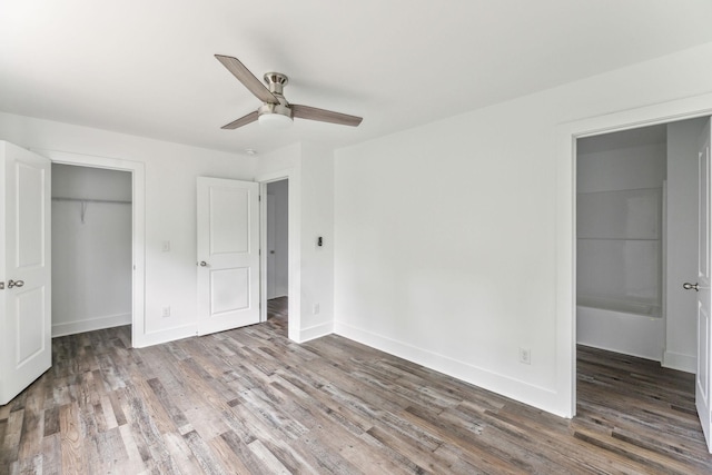 320 Moffat St Unit 101, Monteagle, TN 37356 - unfurnished bedroom with a closet, wood finished floors, a spacious closet, and baseboards