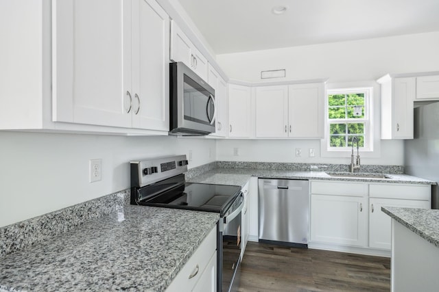 320 Moffat St Unit 102, Monteagle, TN 37356 - kitchen with stainless steel appliances, a sink, white cabinetry, light stone countertops, and dark wood-type flooring
