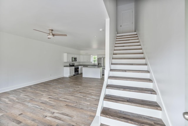 320 Moffat St Unit 103, Monteagle, TN 37356 - stairs with wood finished floors, a ceiling fan, and baseboards