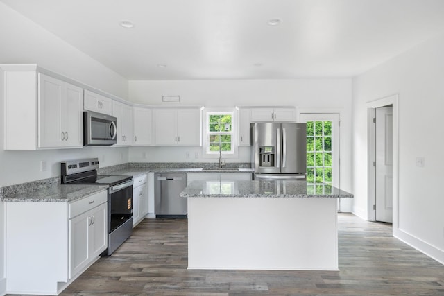 320 Moffat St Unit 103, Monteagle, TN 37356 - kitchen featuring stainless steel appliances, a sink, white cabinetry, a center island, and light stone countertops