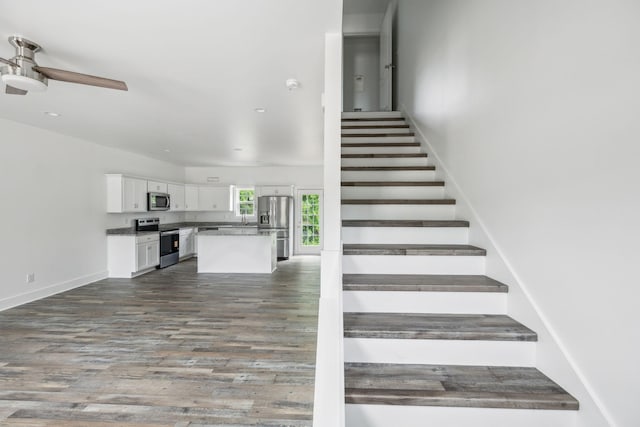 320 Moffat St Unit 103, Monteagle, TN 37356 - staircase with a ceiling fan, wood finished floors, and baseboards