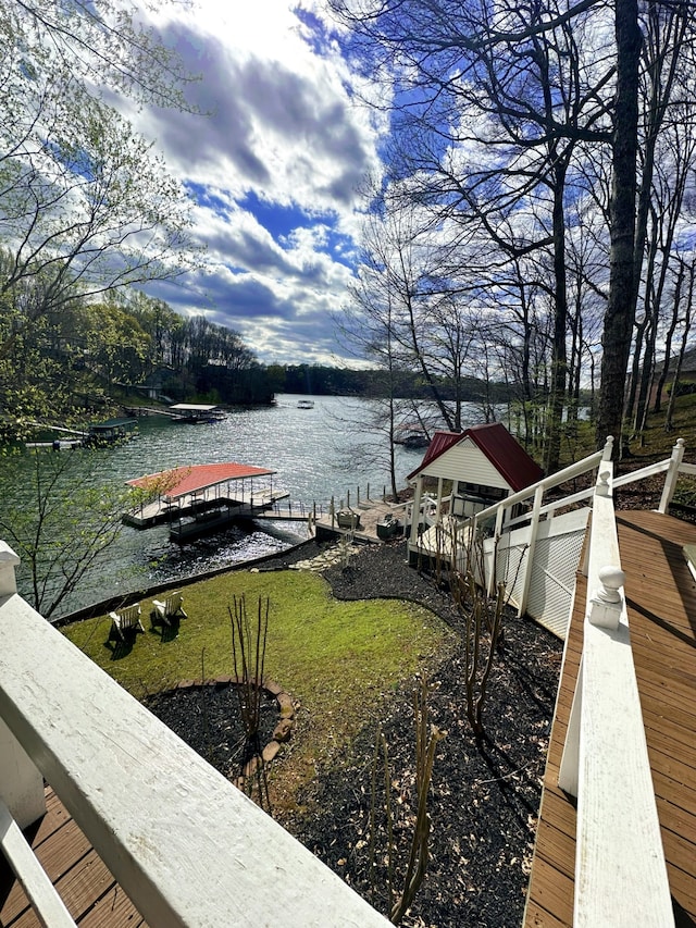 dock area featuring a water view and a yard