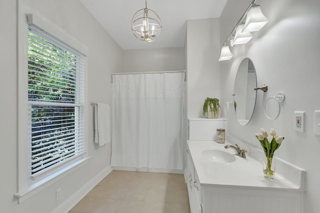 bathroom with vanity, a notable chandelier, and tile patterned floors