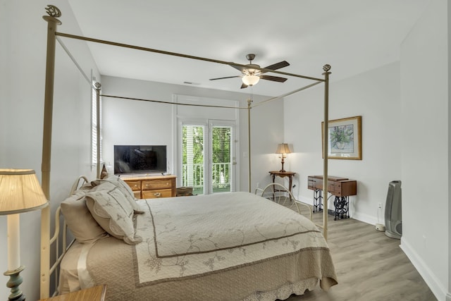 bedroom featuring ceiling fan, light hardwood / wood-style flooring, and access to exterior