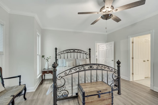 bedroom with light hardwood / wood-style floors, ornamental molding, ceiling fan, and a closet