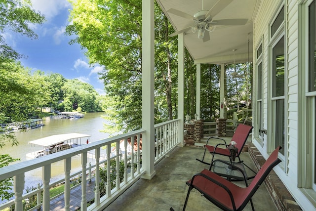 balcony with a water view and ceiling fan