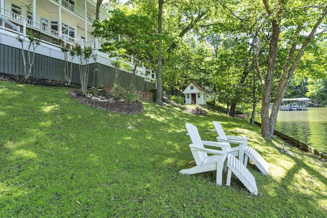 view of yard with a balcony and a water view