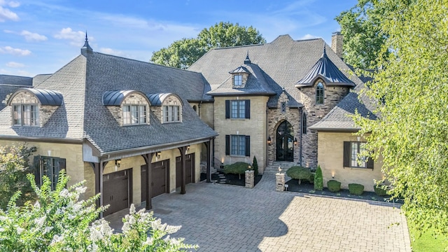 french provincial home featuring a garage