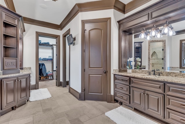 bathroom featuring an enclosed shower, vanity, and crown molding