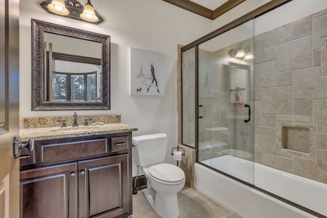 full bathroom with tile patterned flooring, shower / bath combination with glass door, crown molding, vanity, and toilet