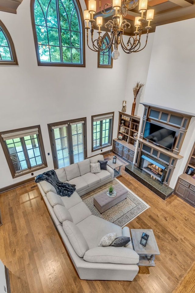 living room featuring a wealth of natural light, wood-type flooring, and a high ceiling