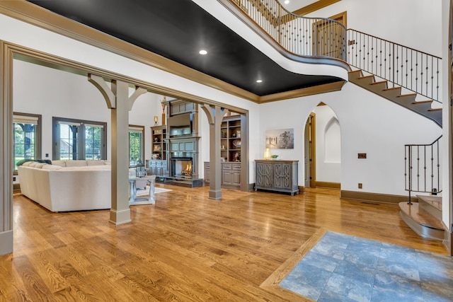 entryway featuring a towering ceiling and light hardwood / wood-style flooring