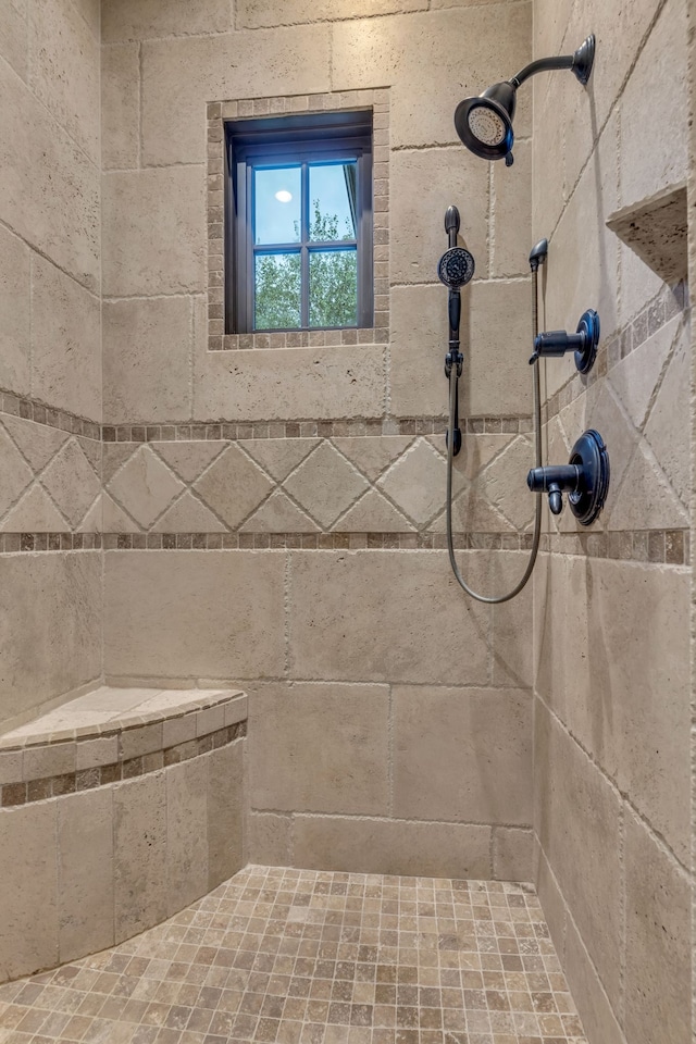 bathroom with tiled shower