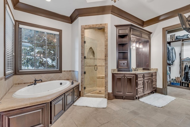 bathroom with independent shower and bath, vanity, and ornamental molding