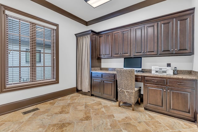 office featuring built in desk and crown molding