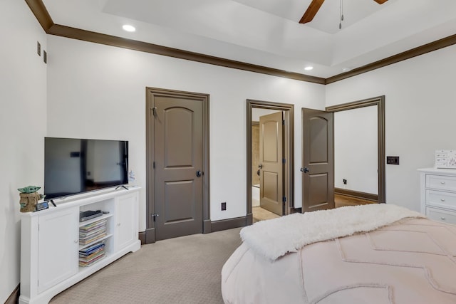 carpeted bedroom with ceiling fan, ensuite bath, and ornamental molding