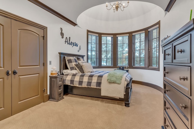 bedroom with an inviting chandelier and light colored carpet