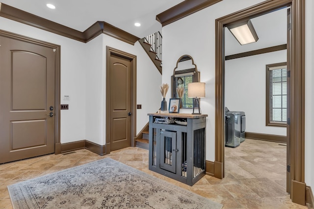 corridor featuring separate washer and dryer and ornamental molding