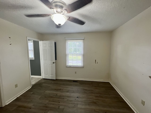 unfurnished bedroom featuring ceiling fan, dark hardwood / wood-style floors, and a textured ceiling