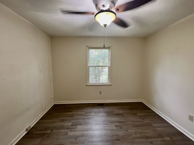 spare room with ceiling fan, a textured ceiling, and dark hardwood / wood-style floors