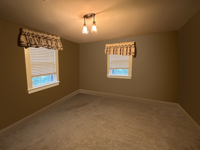 empty room with plenty of natural light and carpet floors