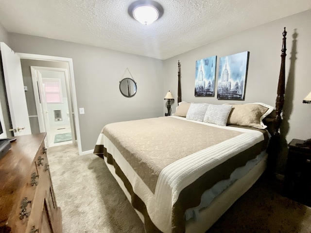 bedroom with a textured ceiling and light carpet