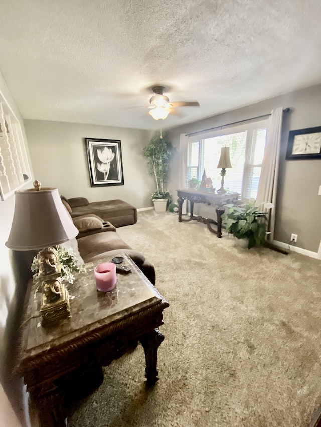 living room with a textured ceiling, carpet, and ceiling fan