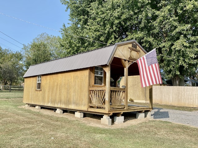 view of outdoor structure featuring a lawn