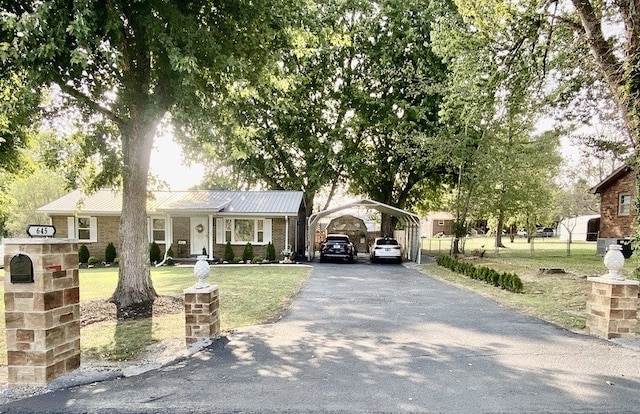 view of front of property with a front lawn and a carport