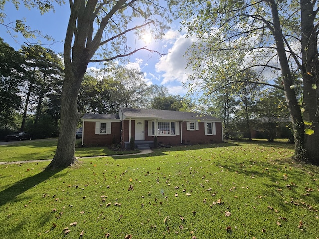 ranch-style home with a front lawn