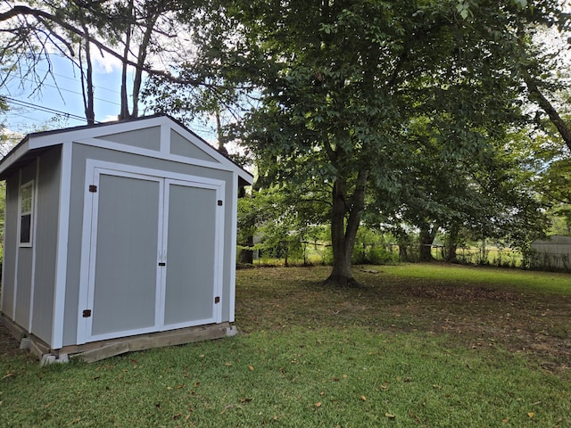 view of outbuilding featuring a yard