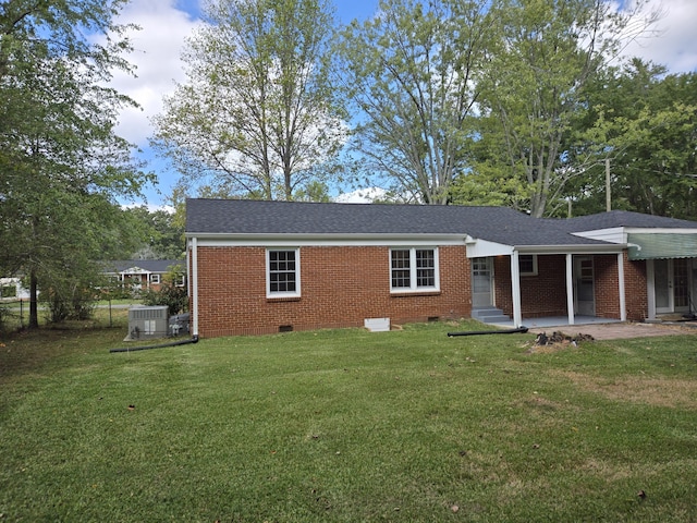 rear view of house featuring a lawn and a patio area