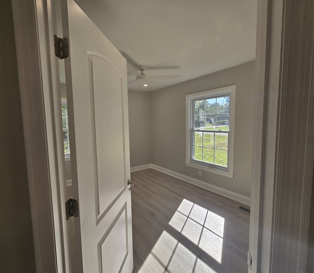 unfurnished room with dark hardwood / wood-style flooring and ceiling fan