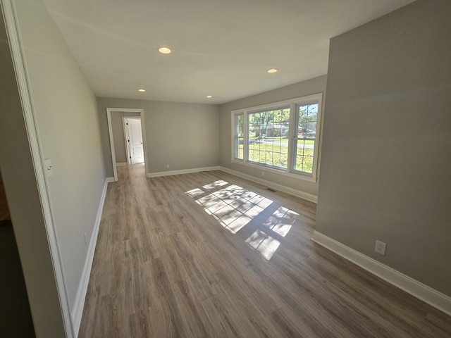 unfurnished room with wood-type flooring