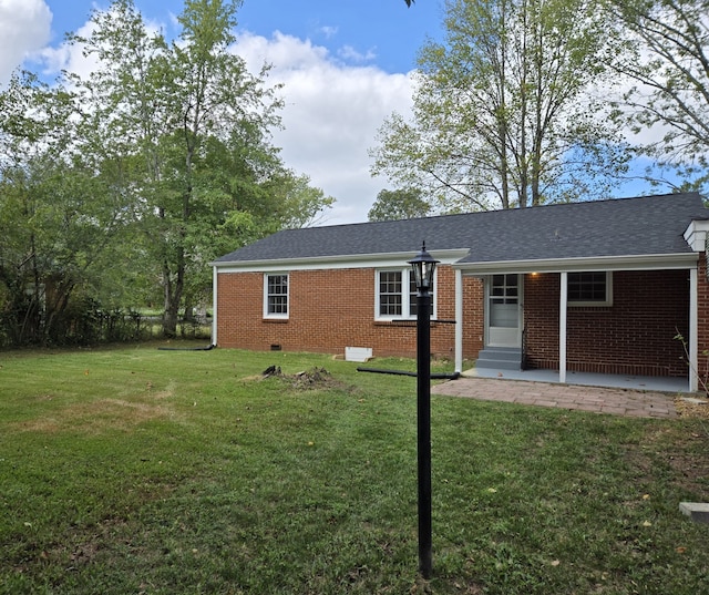 back of house with a yard and a patio area