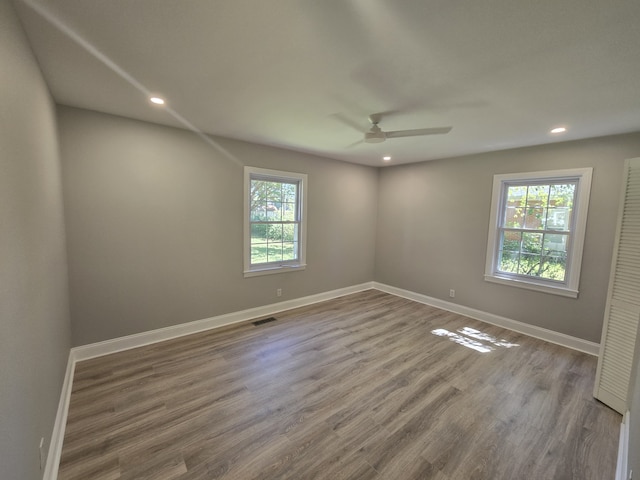 unfurnished room with hardwood / wood-style floors and ceiling fan