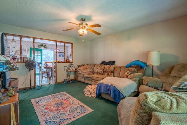 living room featuring a textured ceiling, dark colored carpet, and ceiling fan