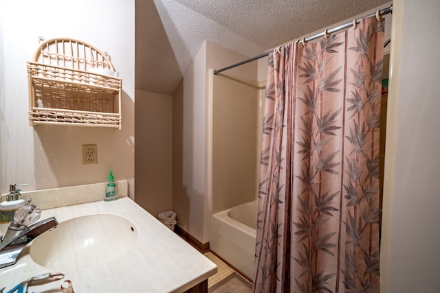 bathroom featuring vanity, shower / tub combo, and a textured ceiling