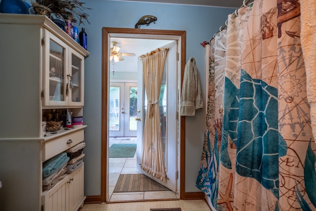 bathroom featuring ceiling fan and tile patterned floors