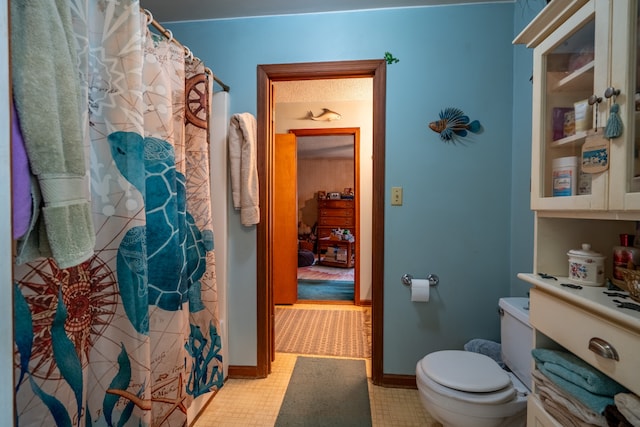 bathroom with tile patterned flooring and toilet