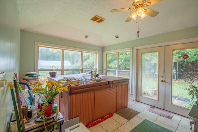 sunroom featuring ceiling fan, lofted ceiling, french doors, and a wealth of natural light