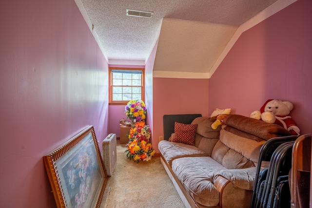 living room featuring a textured ceiling, carpet, and lofted ceiling