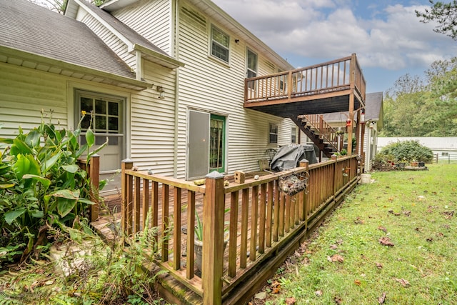 view of side of property featuring a deck and a yard