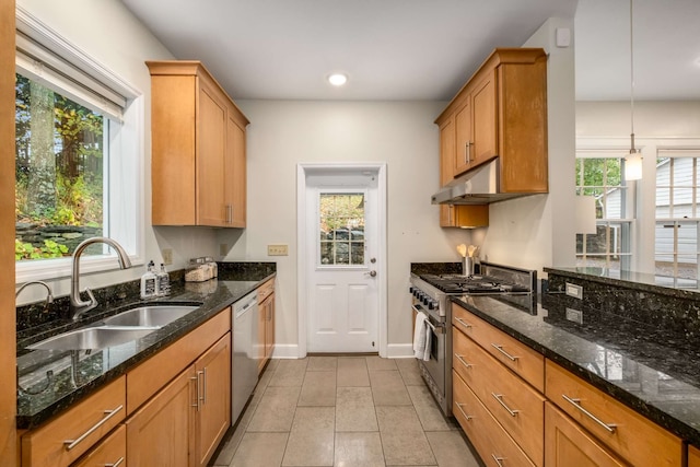 kitchen with sink, stainless steel appliances, hanging light fixtures, and dark stone countertops