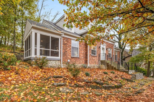 view of side of property featuring a sunroom